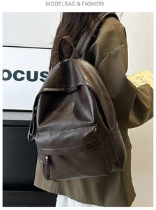 Close-up of deep brown soft PU leather backpack with vintage texture and zipper detail