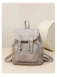 Close-up of grey vintage PU leather backpack featuring golden buckles and ring zipper detail