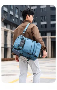 Detail of light blue travel backpack with multi-pocket structure and mesh shoulder pads