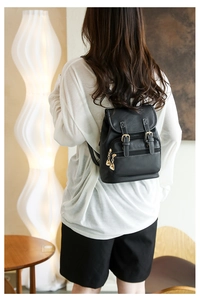 Detail shot of black PU leather backpack with heart zipper and white contrast stitching