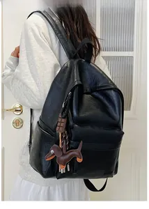 Large black PU leather backpack detail with dog and chocolate charm on a model