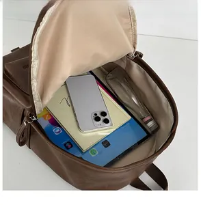 Top view of large capacity brown leather backpack showing spacious interior storage