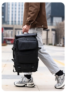Detailed view of durable black travel backpack with multiple zippered pockets and buckles