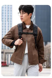 Close-up of a brown canvas cargo jacket featuring classic collar and metal snap pockets