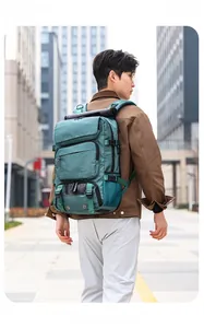 Detail of teal outdoor backpack featuring multi-pocket design and adjustable side buckles