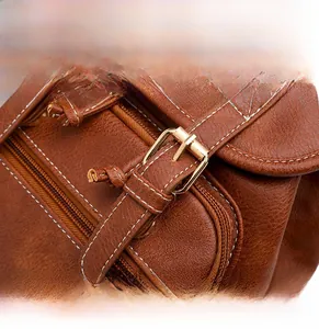 Detail of brown litchi pattern PU leather with metal buckle and contrast stitching