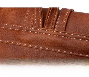 Close-up of durable white stitching on brown lychee pattern leather backpack strap