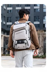 Outdoor shot of lightweight light grey multi-pocket travel backpack with urban style