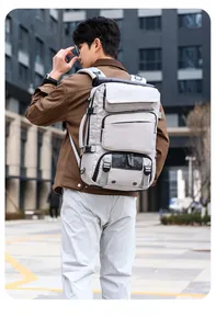 Rear view of a light grey multifunctional tactical backpack with multiple storage compartments