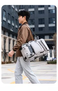 Close-up of lightweight grey travel duffel bag with waterproof nylon fabric and side mesh pocket