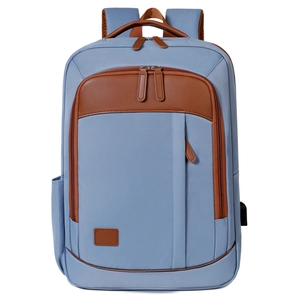 Light blue canvas laptop backpack with brown leather trim and USB port for travel