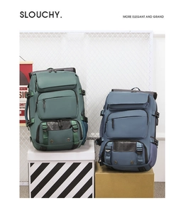 Deep green and blue-grey travel backpacks featuring multiple functional compartments and buckles