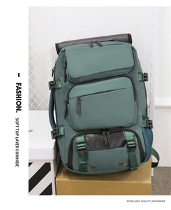Detail view of large travel backpack with leather accents and multi-zipper compartments