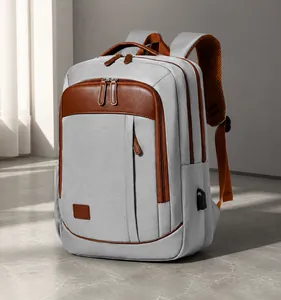 Grey business backpack detail showing side USB port and brown leather trim accents