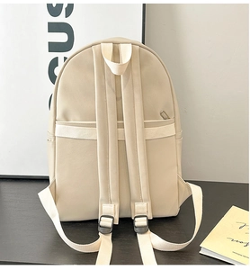 Rear view of a beige PU leather backpack with adjustable straps and back pocket