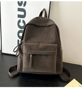 Detail view of large front zipper pocket on vintage dark brown PU leather backpack