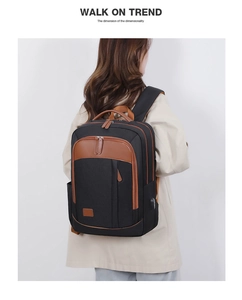 Business laptop backpack in black with brown leather handle and external USB charging port