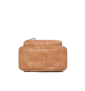 Detail view of the brown leather backpack bottom with clean stitching and black zipper