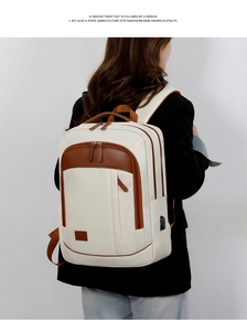 Detail of commuter laptop backpack in beige with brown leather trim and USB port