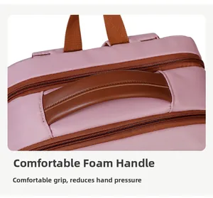 Close-up of pink backpack with comfortable padded handle and brown leather trim detail
