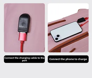 Detail view of pink commuter backpack featuring built-in USB charging port with red cable