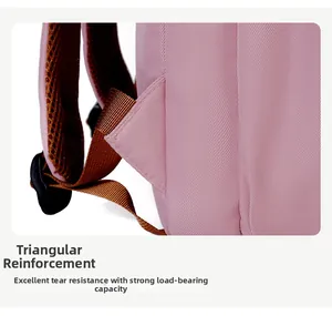 Detail view of triangular reinforcement stitching on pink backpack shoulder straps for durability