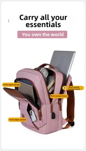 Detail view of pink and brown laptop backpack featuring USB port and multi-layer storage