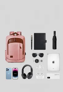 Pink business laptop backpack showing storage capacity with electronics and gadgets