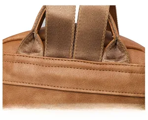 Detail shot of sturdy double stitching on a brown vintage leather backpack shoulder strap