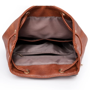 Retro brown PU leather backpack featuring a spacious interior with multiple pockets