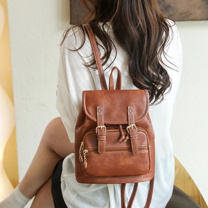 Vintage brown PU leather backpack with buckle straps and leaf pendant in back view
