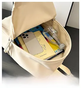 Detailed overhead view of the beige PU leather backpack showing its spacious main compartment