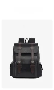 Detail of 15-inch black commuter backpack with brown faux leather straps and lychee texture