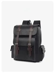 Detail view of black vintage leather backpack with brown straps and metal buckles