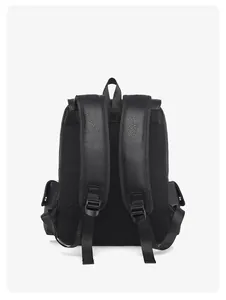 Detail view of the breathable mesh back and padded shoulder straps on black leather backpack