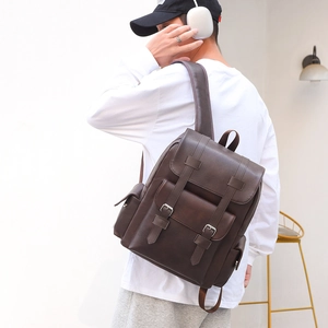 Retro dark brown leather backpack with buckle straps shown on model for daily travel use