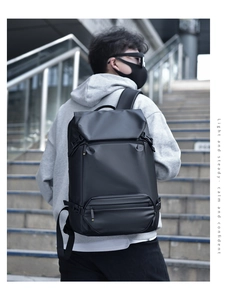 Photo en extérieur d'un sac à dos d'affaires noir avec tissu imperméable et poches avant