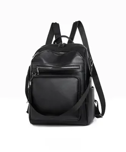 Side view detail of black faux leather backpack showing multi-pocket layers and texture