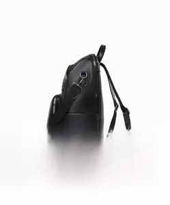 Side view of minimalist black lychee texture PU leather backpack with silver hardware