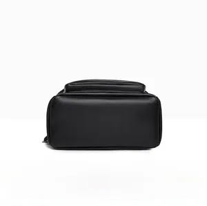 Detailed bottom view of black PU leather backpack showing durable pebbled texture and stitching
