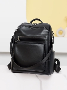 Detail of black pebbled PU leather backpack with multi-zipper pockets and hardware