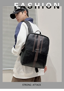 Men's minimalist black and brown PU leather backpack shown on a model for daily use