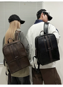 Detail shot of black and brown minimalist leather backpacks on male and female models