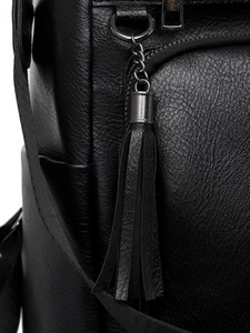 Close-up of black lychee texture PU backpack featuring a long tassel zipper pull detail