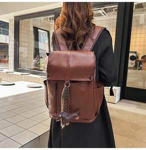 Brown PU leather backpack with dachshund charm shown from a 45-degree back angle