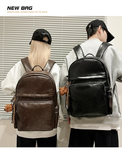 Rear view of black and brown PU leather backpacks with plush bears on models