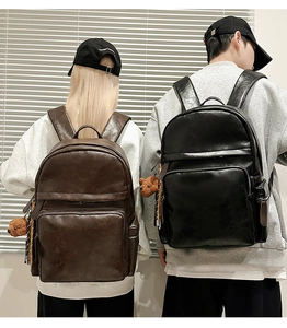 Vintage PU leather backpack shown from behind featuring bear pendant and wide straps