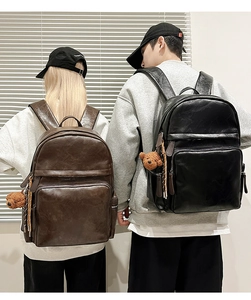 Detail showing vintage PU leather backpacks with plush bear charms and multi-zipper pockets