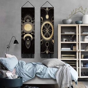 Set of two celestial sun and moon wall tapestries with golden patterns and black tassels