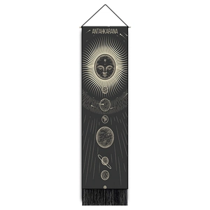 Macro detail of sun and moon wall tapestry showing black fabric and celestial printing
